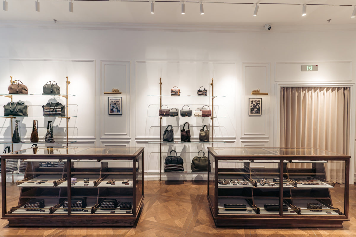Au Départ Gulangyu boutique interior with bag displays and leather goods cabinets