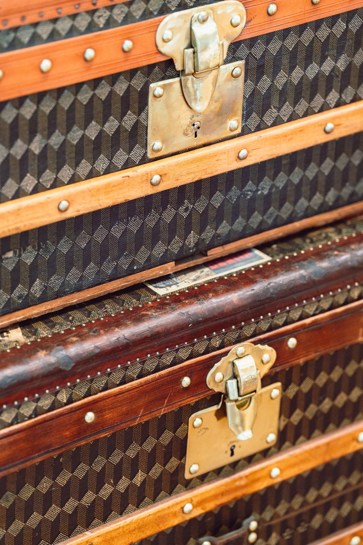 Brass hardware detail on Au Départ monogram trunks